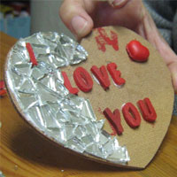 glue tiles in middle of mosaic heart