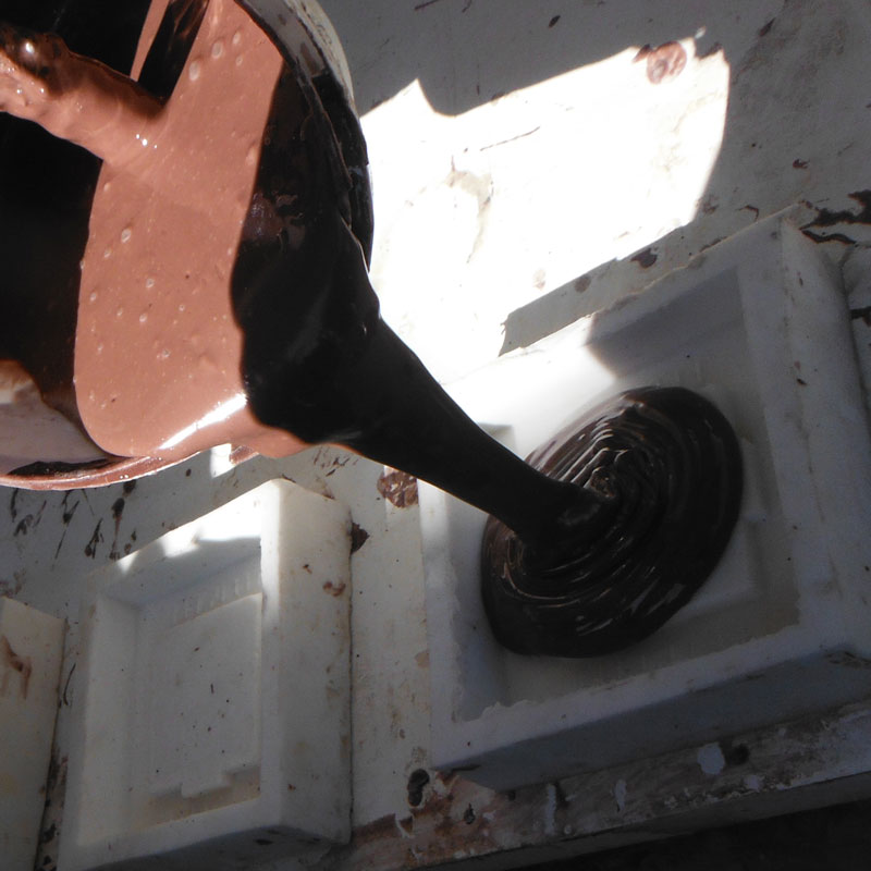 filling silicone rubber mould one third of the way with resin
