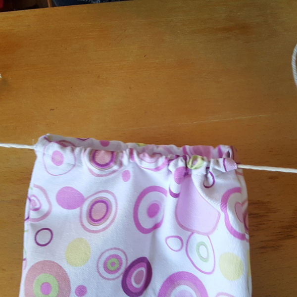 pull on both ends of twine 