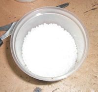 pour wax pellets into container