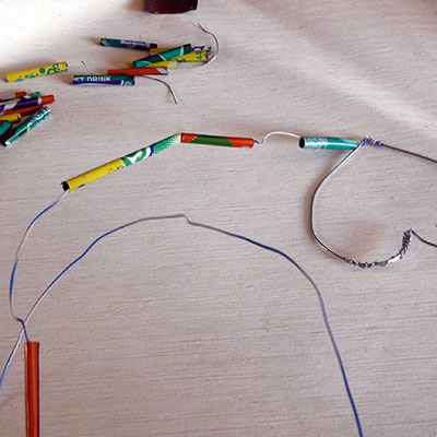 sliding the tin beads onto wire