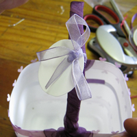 tie recycled plastic disk on to easter basket