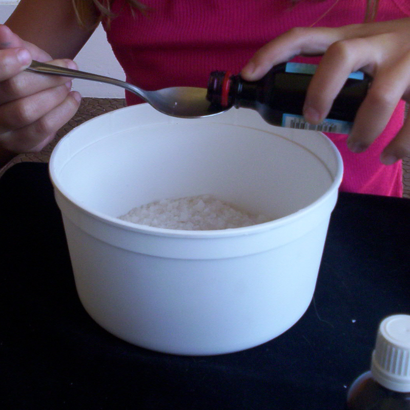 bowlsof coarse salt with red food colouring about to be added in 