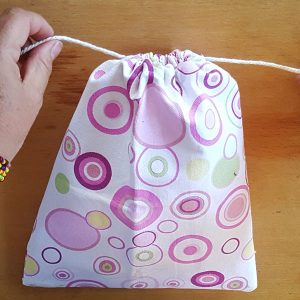 hand made drawstring bag with purple dots on the fabric
