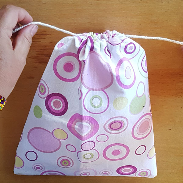 hand made drawstring bag with purple dots on the fabric