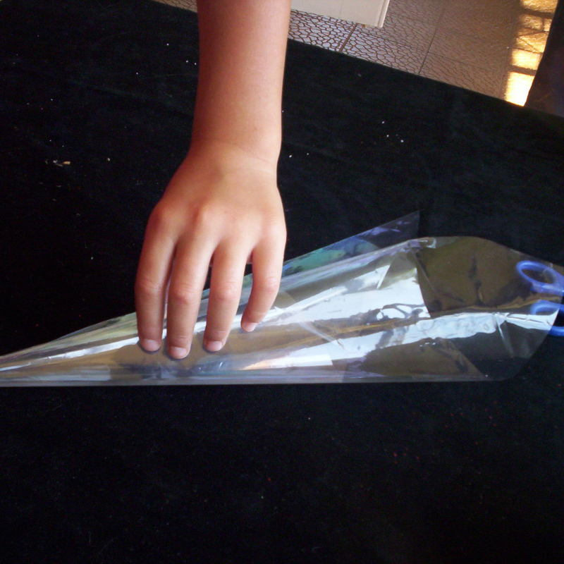 clear plastic sleeve folded into a cone shape and sealed at the point with sticky tape