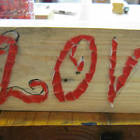 mosaic love onto wooden timber