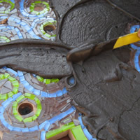 spreading grout on design