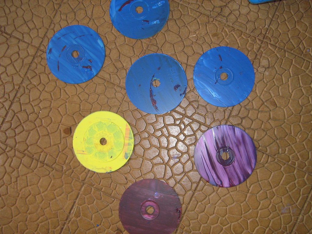 cds with two coats or paint on drying