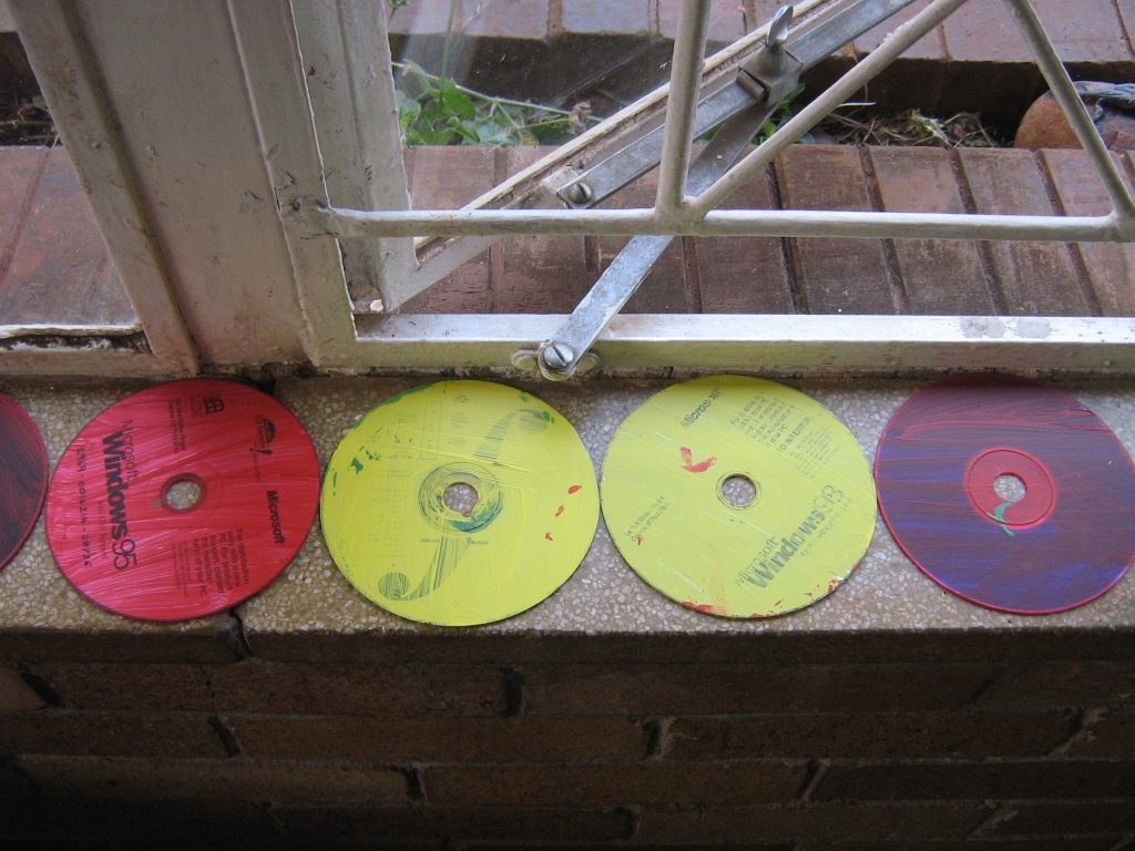cds with one coat of paint on them