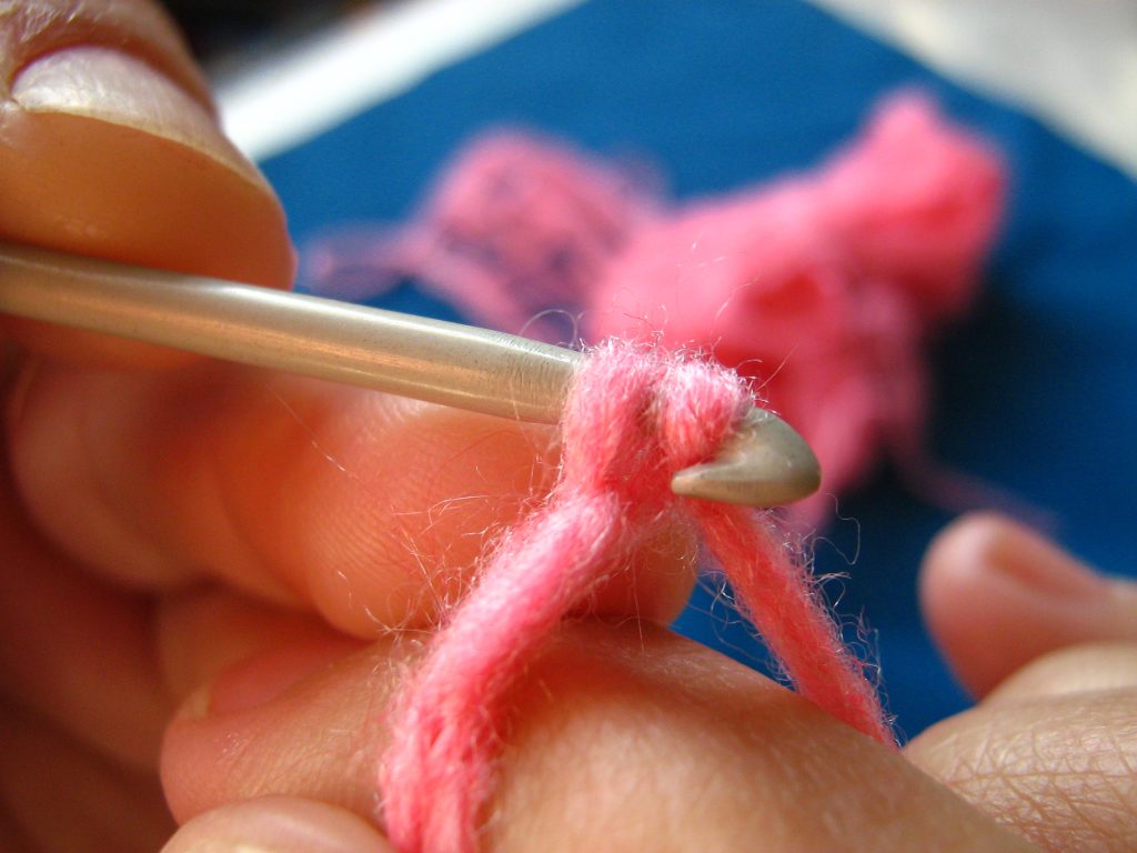 Hands crocheting yarn during a crochet class at Crafty Corner in Johannesburg