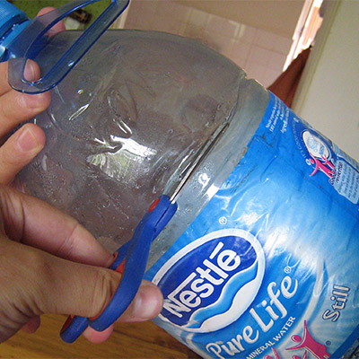 scissors cutting bottle