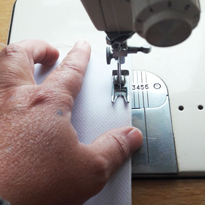 canvas banner been sewn along the edge with tacking stich